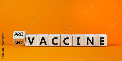 Pro-vaccine or anti-vaccine symbol. Turned a cube, changed words 'anti-vaccine' to 'pro-vaccine'. Beautiful orange background. Copy space. Medical covid-19 pro-vaccine or anti-vaccine concept.