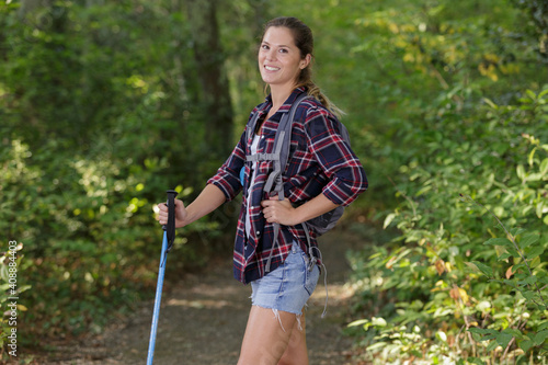 portrait of woman on nature walk holding a cane