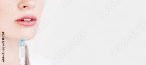 Plastic surgery. Young woman geting cosmetic injection in lips
