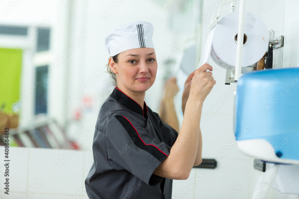 canteen worker taking disposable kitchen paper