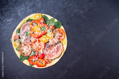 Banner Pizza with cheese, tomatoes, bacon, pepper, spinach. On a blue background. Horizontal orientation.