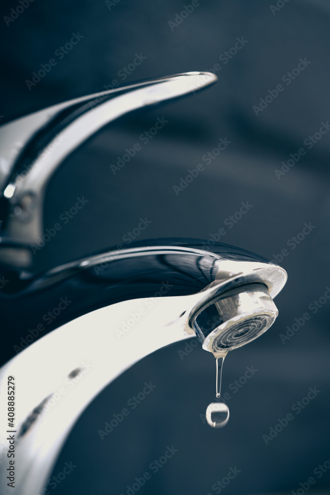 water drop dripping from the tap and water shortage water drop dripping from the tap and water shortage