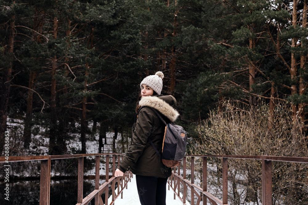 Fototapeta premium Woman crossing a bridge over a swamp