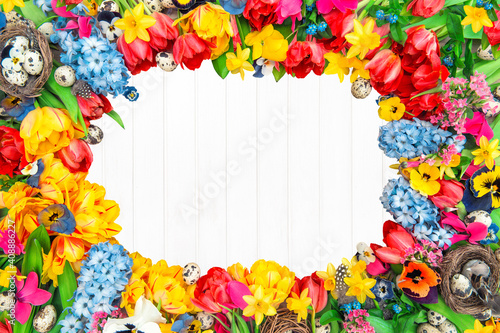 Holidays background from spring flowers and easter eggs