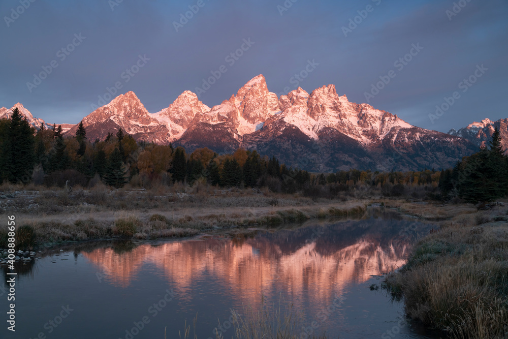 autumn dawn view of grand teton and its reflection at schwabacher landing in grand teton national park