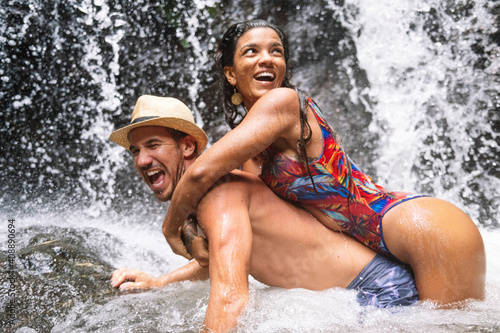Young couple in love at the waterfall in Costa Rica