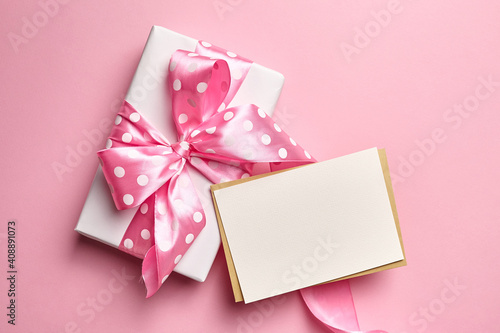 Greeting card mockup with gift box on pink background © mikeosphoto