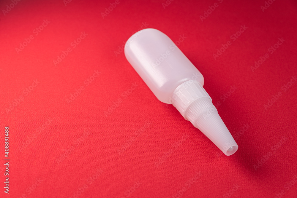 Glue bottle on the colorful background Glue bottle on the colorful background