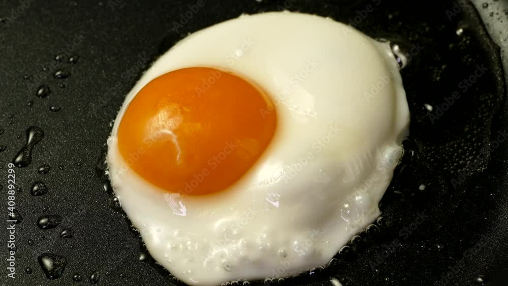 The egg is fried in a pan. Breakfast with scrambled eggs. Yolk and protein. The egg is fried in a pan. Breakfast with scrambled eggs. Yolk and protein.