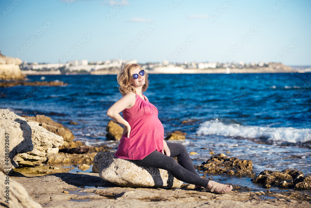 Portrait of beautiful pregnant woman at beach