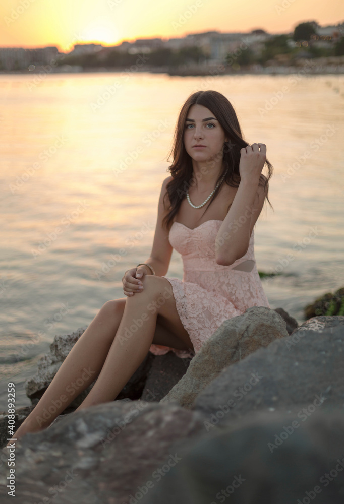 Young slim beautiful woman on sunset beach