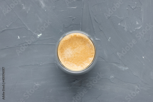 Trendy glass cup of espresso with crema on gray rustic backround. Flat lay, top view, copy space, social media hero header template. Coffee break concept