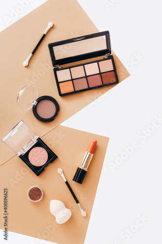 Flat lay with set of professional decorative cosmetics, makeup tools with copy space.