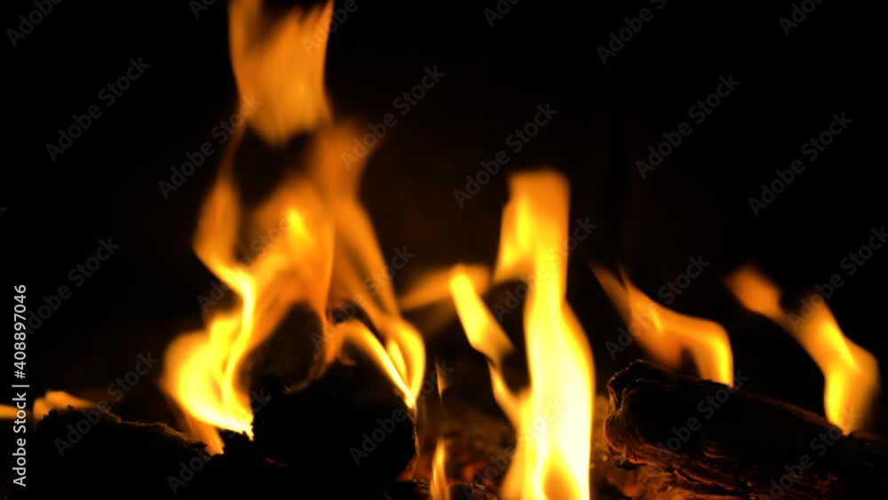 Closeup shot of fire sparks moving on dark at black background Closeup shot of fire sparks moving on dark at black background