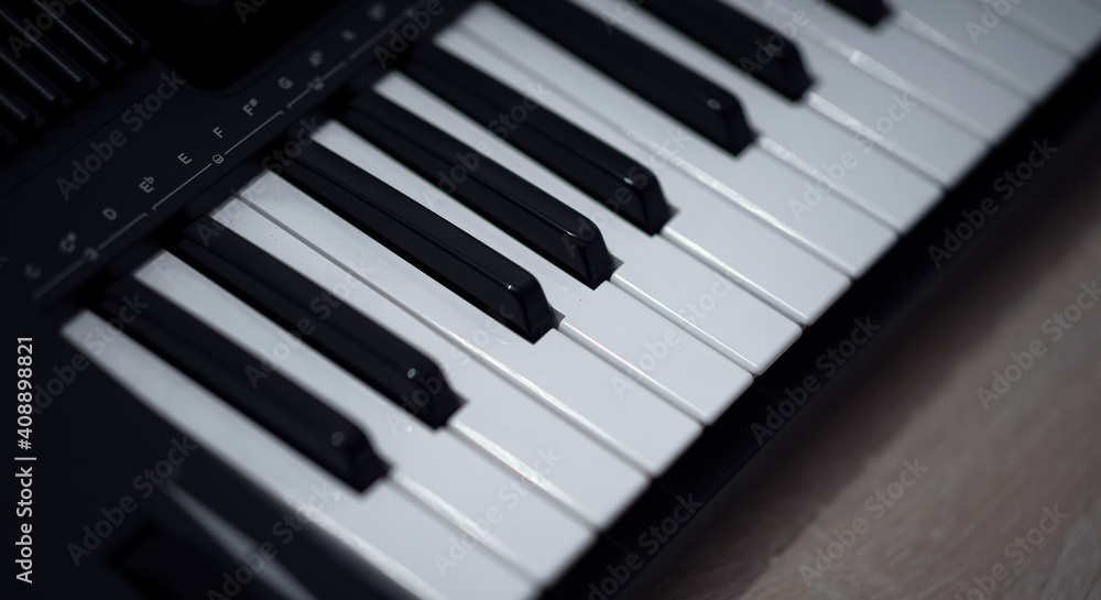 Electronic piano keyboard. Closeup of black and white piano keys