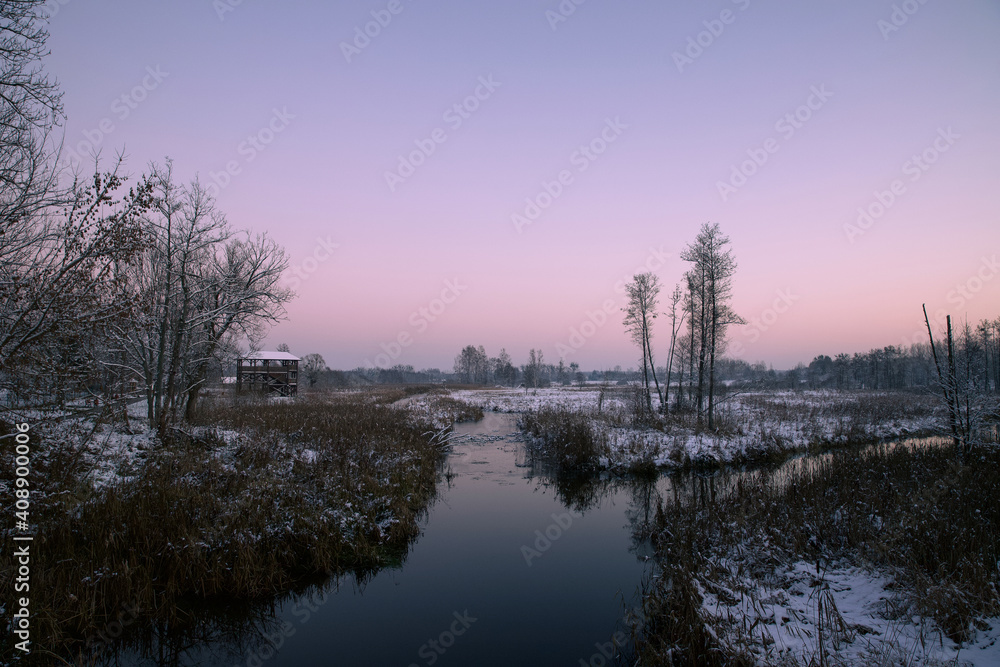 Winter landscape on the river at dusk.