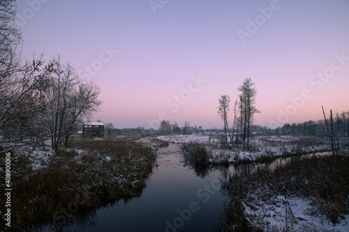Winter landscape on the river at dusk.