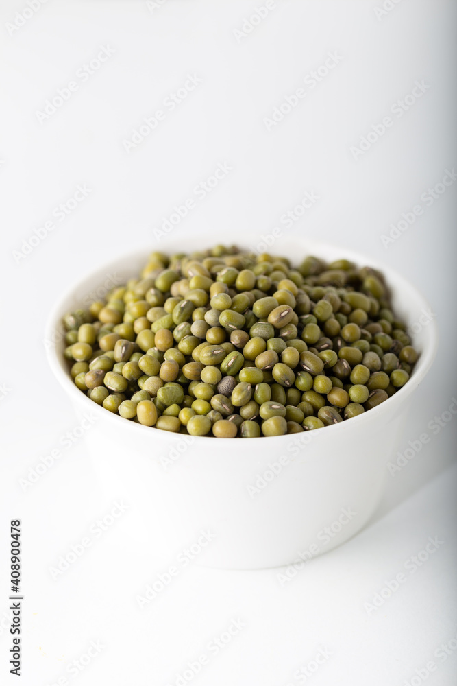 Bowl of uncooked mung beans on white background. Bowl of uncooked mung beans on white background.