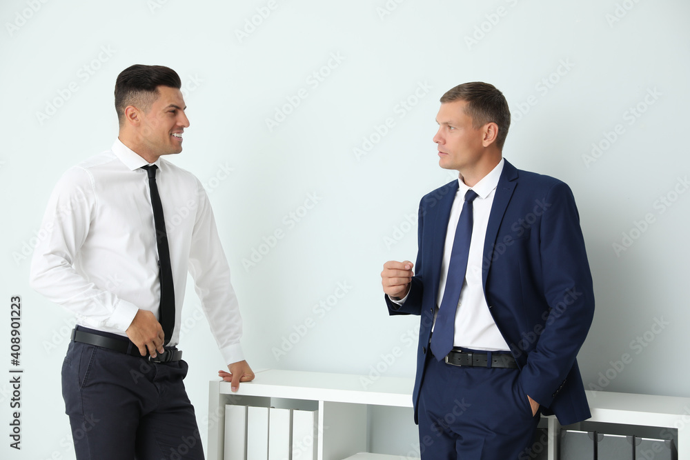 Office employees talking at workplace during break