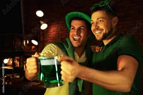 Men with beer celebrating St Patrick's day in pub