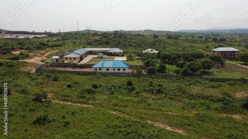 Aerial tropical forest orphanage Ghana Africa. Homes, apartment, playgrounds, library and facilities to help young boys and girls escape slave and child labor. Volunteer facility. Tropical forest land