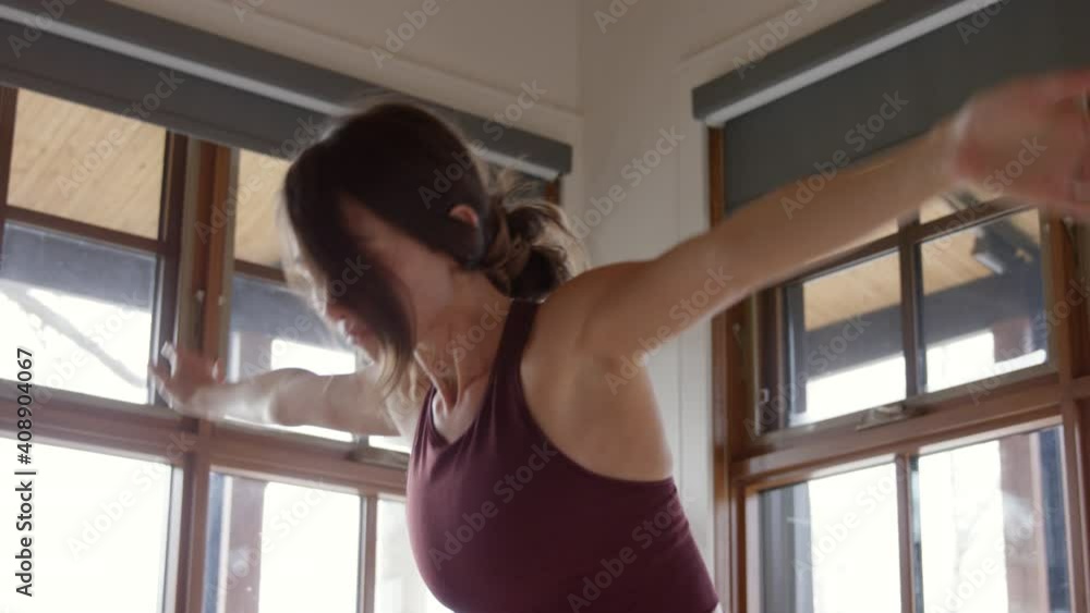 Woman in 20s does morning streches bending over crossing arms - hand held Woman in 20s does morning streches bending over crossing arms - hand held