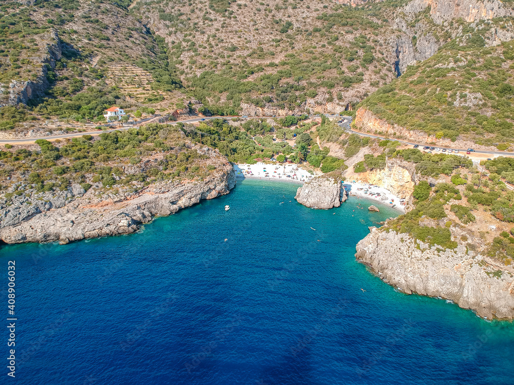 Aerial view of the famous rocky beach Foneas near Kardamyli village in the seaside Messenian Mani area during high tourist Summer period. Messenia, Peloponnese, Greece.