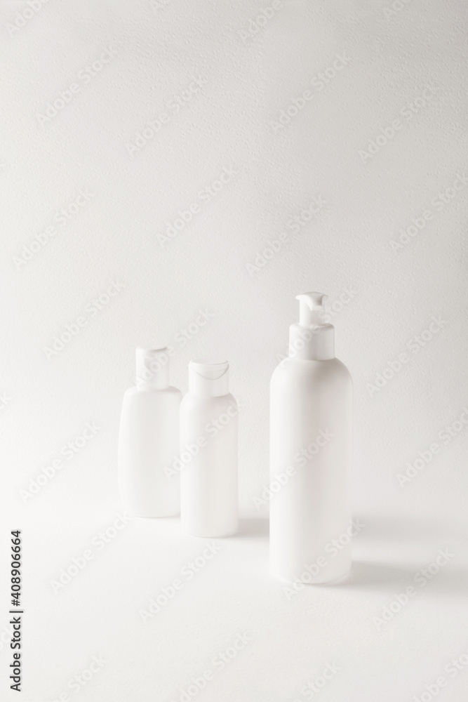 White bottles mockup for branding. Set of cosmetic products for cream, soup, deodorant, shampoo on light biege background. Tubes, dispensers and jars