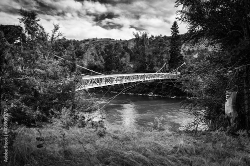 Suspension bridge to an island in the Missouri River, in Montana (Black and White) photo