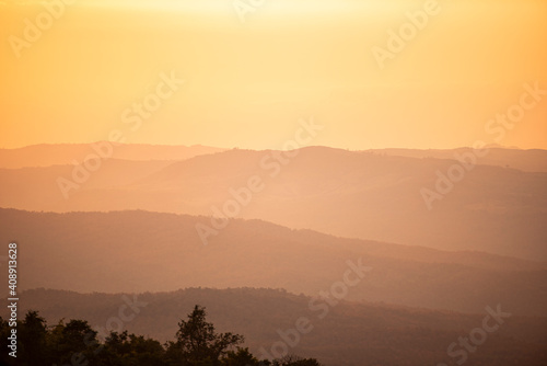 View sunset on mountain with hill warm light sun  Beautiful landscape tree nature sunrise.