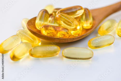 Fish oil capsules with omega 3 and vitamin D Cod liver oil omega 3 gel capsules, healthy diet concept.