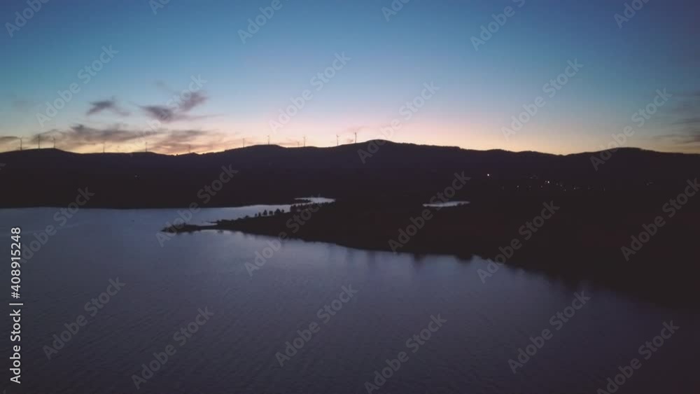 Rio Rabagão sunset almost night behind the mountains - Drone aerial shot above the water in Portugal, Montalegre Rio Rabagão sunset almost night behind the mountains - Drone aerial shot above the water in Portugal, Montalegre