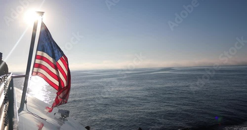 Boat With American Flag Sailing In Ocean