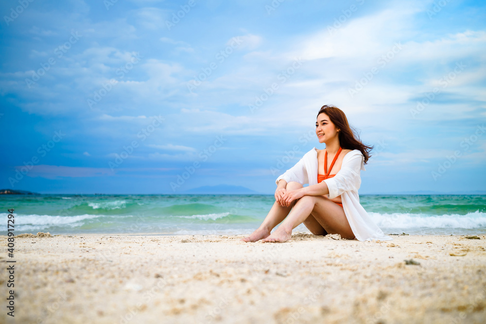 woman sitting on sea beach at Koh MunNork Island, Rayong, Thailand