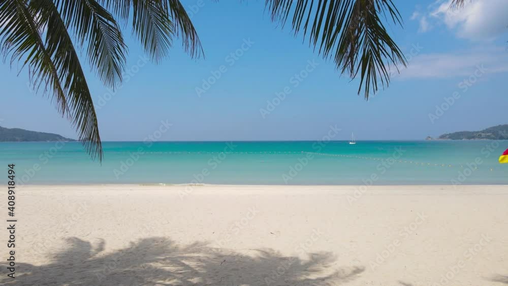 Phuket Thailand Beach Sea. Scene of Landscape view of Palm at beach Beach sand on blue sea water clear and sky clear background. Camera on dolly slide. At Patong Beach, Phuket, Thailand. Phuket Thailand Beach Sea. Scene of Landscape view of Palm at beach Beach sand on blue sea water clear and sky clear background. Camera on dolly slide. At Patong Beach, Phuket, Thailand.