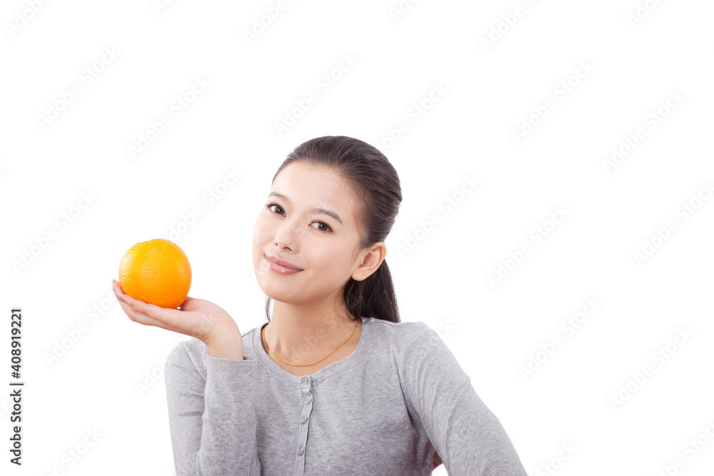 Oriental fashion female holding an orange Oriental fashion female holding an orange