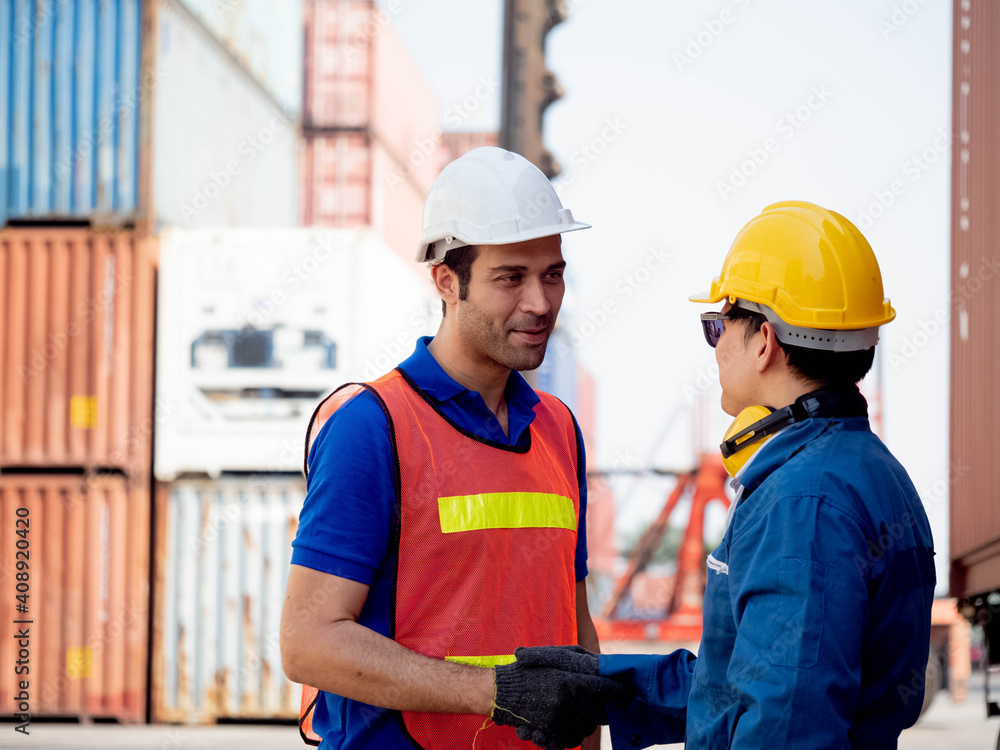 Terminal container male foreman engineering manager factory hat white yellow shake hand businessmen customer warehouse site technology import export agreement contract project success teamwork Terminal container male foreman engineering manager factory hat white yellow shake hand businessmen customer warehouse site technology import export agreement contract project success teamwork
