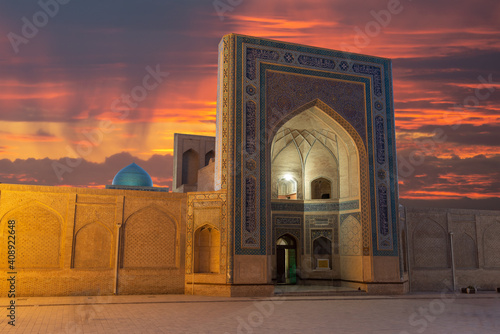 Kalan Mosque facade at Po-I-Kalan religious complex in Bukhara, Uzbekistan during sunset. Mosque iwan decorated at Poi Kalan. Kalon Mosque. photo