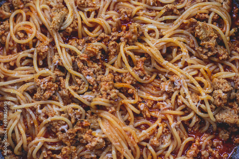 Pasta bolognese pan, homemade prepared close up view, classic italian spaghetti noodle with minced meat beef, tomato sauce and parmesan cheese