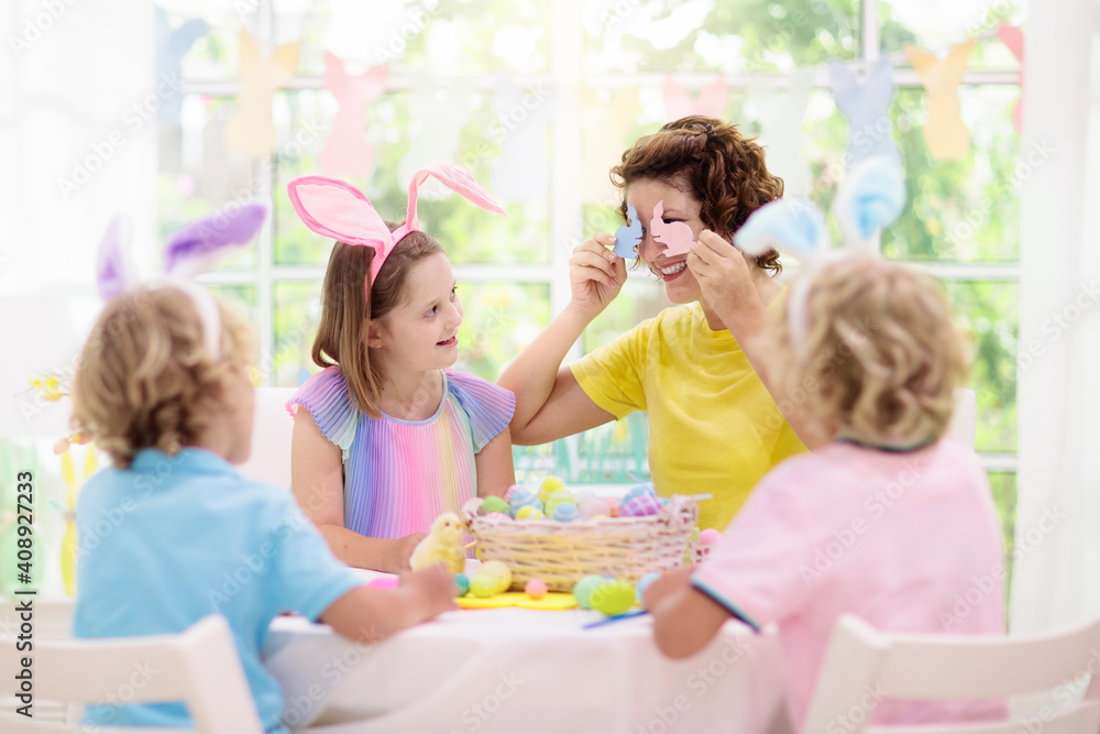 Mother and kids, family coloring Easter eggs. Mother and kids, family coloring Easter eggs.