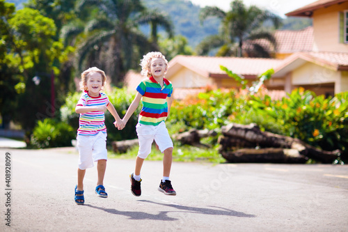 Kids running. Children run on city street.