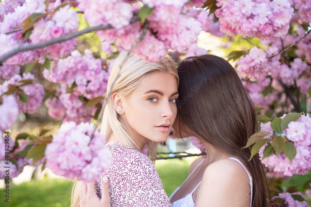 Fototapeta premium Girls in flowers. Woman in the spring garden.