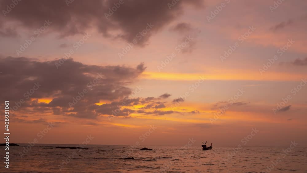 Patel sweet Pink colorful sky and a small silhouette fishing boat in sunset time. Cloudscape background timelapse footage. Orange clouds and golden sunlight sprayed over sky.nature landscapes Patel sweet Pink colorful sky and a small silhouette fishing boat in sunset time. Cloudscape background timelapse footage. Orange clouds and golden sunlight sprayed over sky.nature landscapes