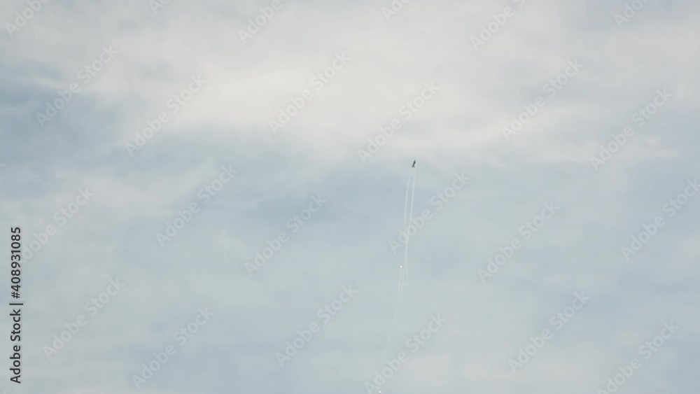 Aerobatic Airshow Display with F16 Fighter Jet Plane, Climbing and Shooting Flares while doing Acrobatic Manoeuvres under Open Blue Sky Aerobatic Airshow Display with F16 Fighter Jet Plane, Climbing and Shooting Flares while doing Acrobatic Manoeuvres under Open Blue Sky
