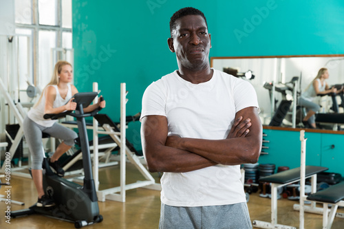 Portrait of adult african man in sportswear welcoming to sport club