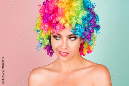 Funny girl clown. Rainbow wig. Funny, laughing, happy girl.