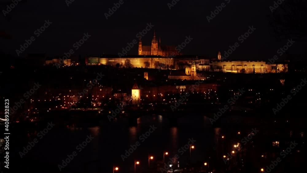 Prague Castle and lit street lights in the evening in the center of Prague Prague Castle and lit street lights in the evening in the center of Prague