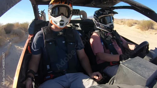 Driver and passenger in an offroad vehicle photo