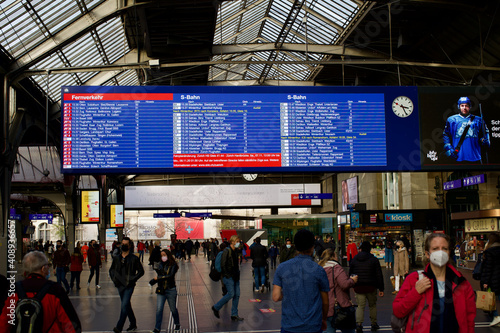 Passengers at main hall of railway main station Hauptbahnhof at Swiss City of Zurich.