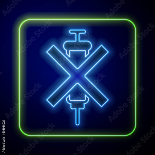 Glowing neon No doping syringe icon isolated on blue background. Vector.